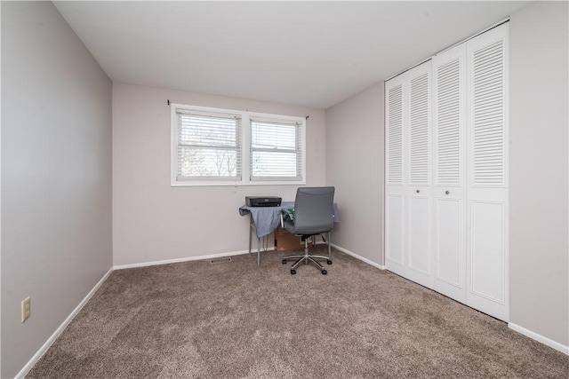 carpeted office featuring baseboards