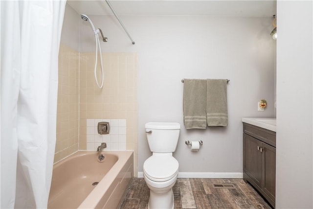 bathroom featuring baseboards, toilet, shower / tub combo with curtain, wood finished floors, and vanity