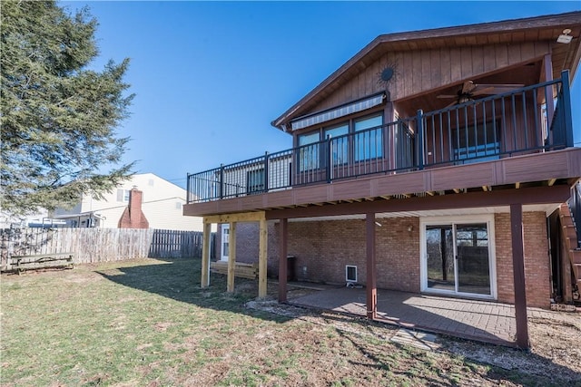 rear view of property with a lawn, a ceiling fan, a patio, fence, and brick siding