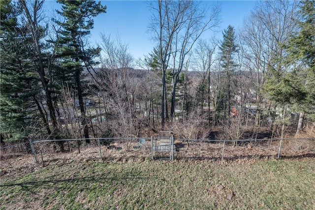 view of yard featuring a view of trees and fence