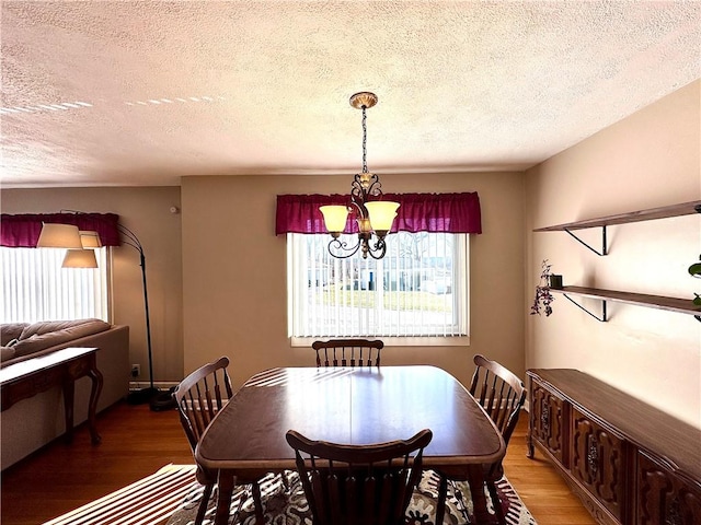 dining space featuring an inviting chandelier and light wood-style floors