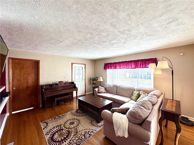 living area featuring a textured ceiling and wood finished floors