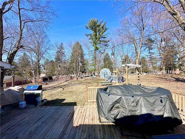 deck featuring a grill and fence