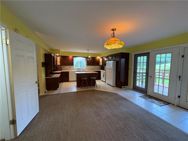 407 Cathedral St, Conemaugh/Young Twps Ind, PA 15681 - kitchen with white appliances, light tile patterned flooring, a kitchen island, and light countertops
