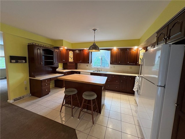 407 Cathedral St, Conemaugh/Young Twps Ind, PA 15681 - kitchen with freestanding refrigerator, a center island, light tile patterned flooring, and backsplash