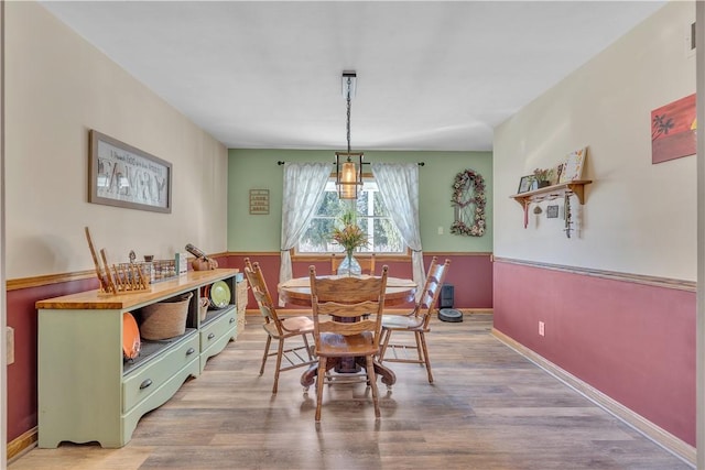 dining area with wood finished floors and baseboards