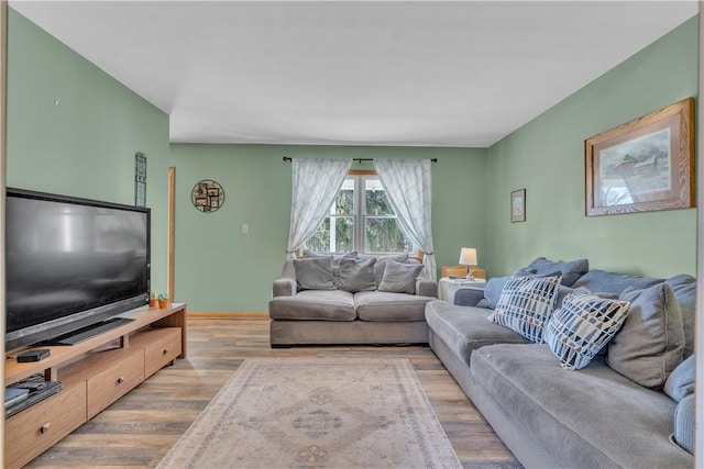 living area featuring light wood-type flooring and baseboards