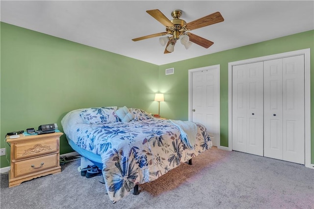 carpeted bedroom featuring visible vents, a closet, and a ceiling fan