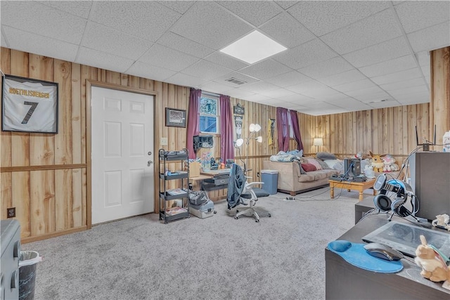 office with visible vents, wood walls, and carpet floors