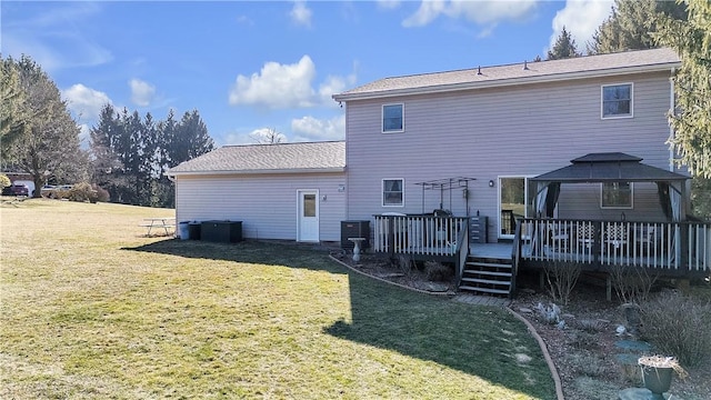 rear view of house with a gazebo, a lawn, and a wooden deck