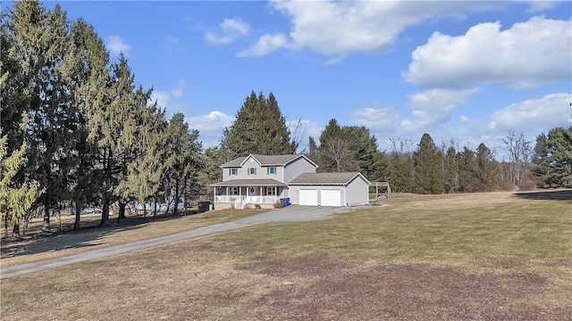 view of front of home featuring a porch, a garage, driveway, and a front lawn