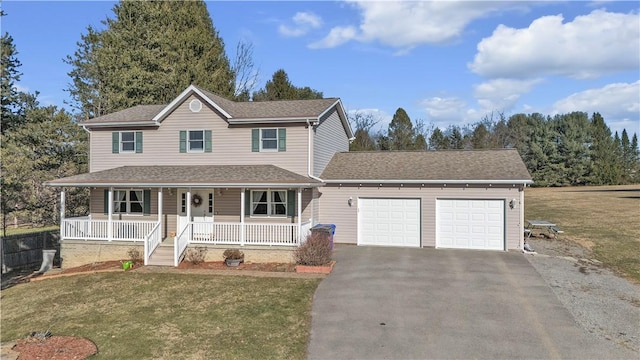 view of front facade featuring a shingled roof, a front yard, covered porch, a garage, and driveway