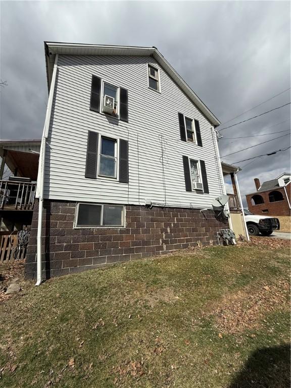 view of side of home featuring a lawn