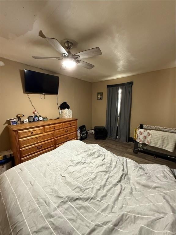 bedroom with wood finished floors and ceiling fan