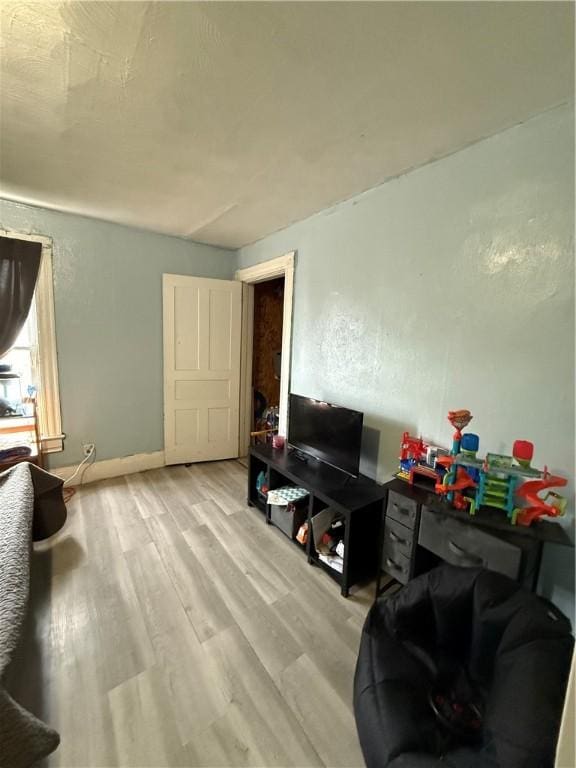 living area with wood finished floors and baseboards