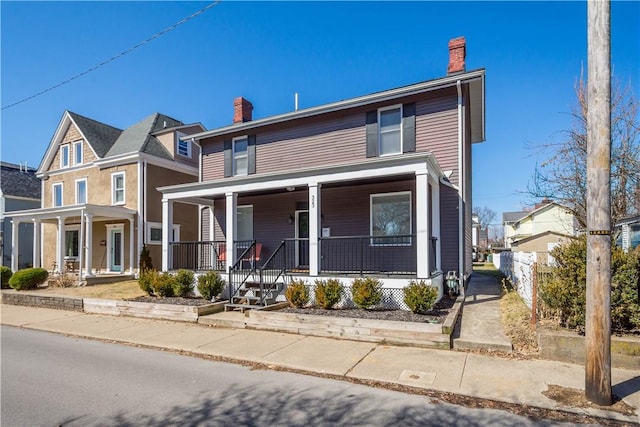 view of front of home with a porch and a chimney