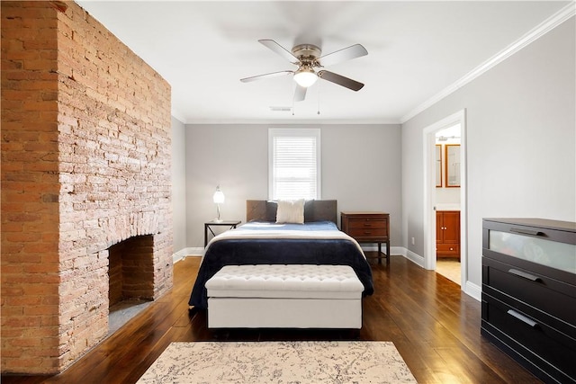 bedroom featuring baseboards, dark wood finished floors, and crown molding