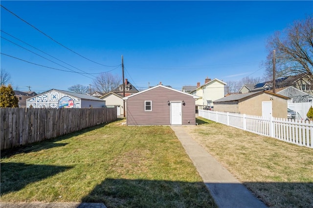 view of yard featuring an outdoor structure and a fenced backyard