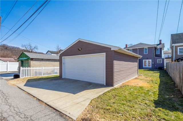 detached garage featuring fence