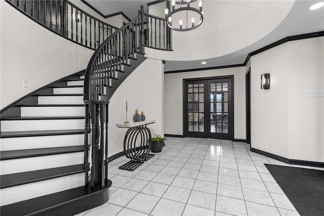 entrance foyer with baseboards, stairs, french doors, a towering ceiling, and crown molding