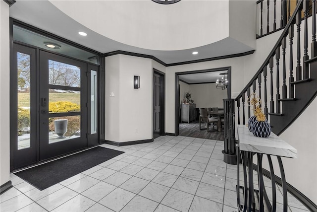 foyer entrance with stairs, recessed lighting, baseboards, and ornamental molding