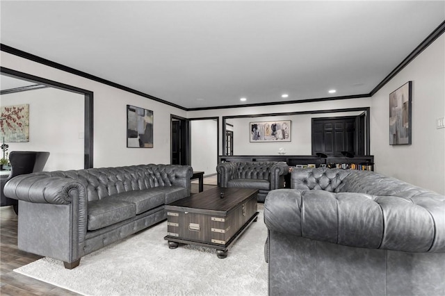 living area with recessed lighting, light wood finished floors, and ornamental molding