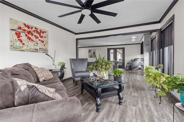 living area featuring wood finished floors, baseboards, ceiling fan, french doors, and crown molding