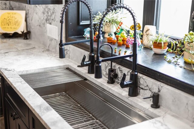 interior details with backsplash and a sink