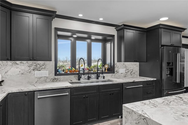 kitchen with a sink, light stone counters, backsplash, stainless steel dishwasher, and high end black fridge