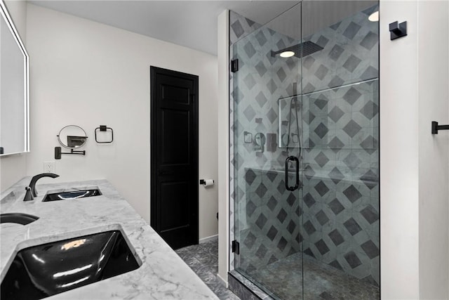 bathroom with a sink, double vanity, and a shower stall