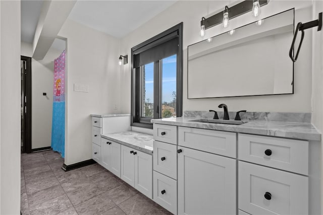 bathroom featuring vanity and baseboards