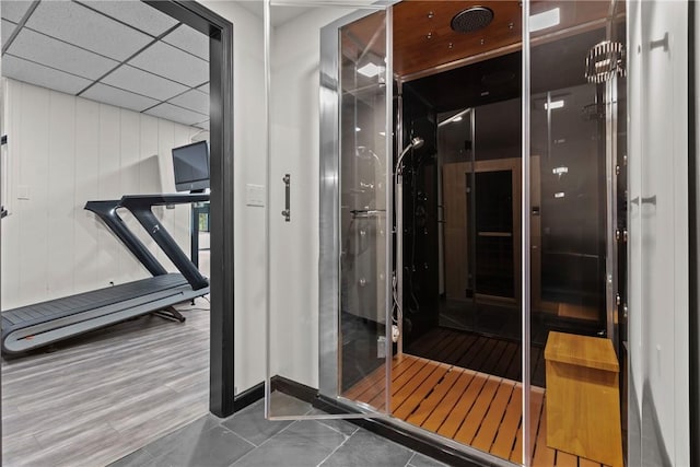 interior space with tile patterned flooring and a drop ceiling