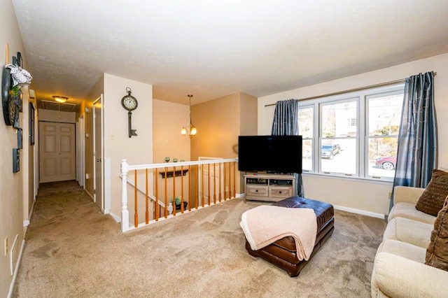 carpeted living room featuring attic access and baseboards