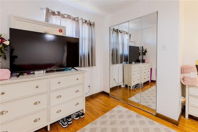 interior space with baseboards and light wood-style floors