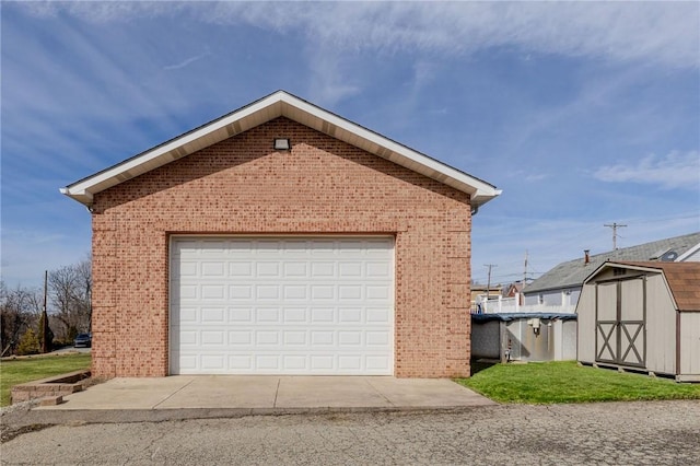 detached garage featuring a shed