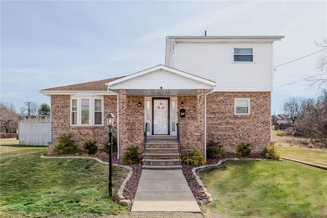 view of front facade with a front lawn, a porch, and brick siding