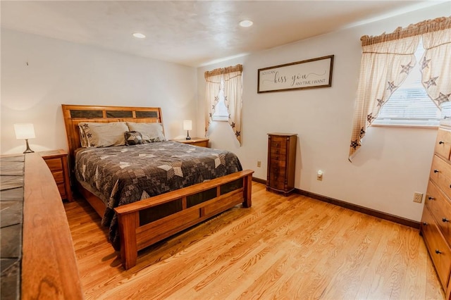 bedroom with recessed lighting, baseboards, multiple windows, and light wood finished floors