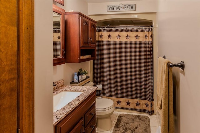 bathroom featuring tile patterned floors, a shower with curtain, vanity, and toilet