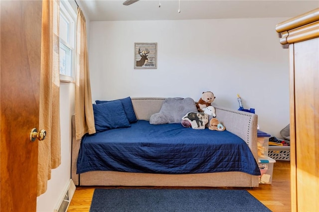 bedroom with visible vents and wood finished floors