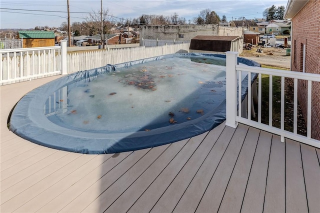 deck with an outbuilding and a storage unit