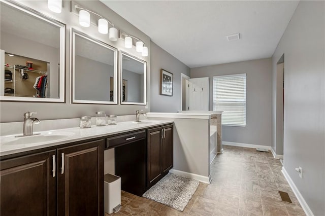 bathroom featuring double vanity, visible vents, and a sink