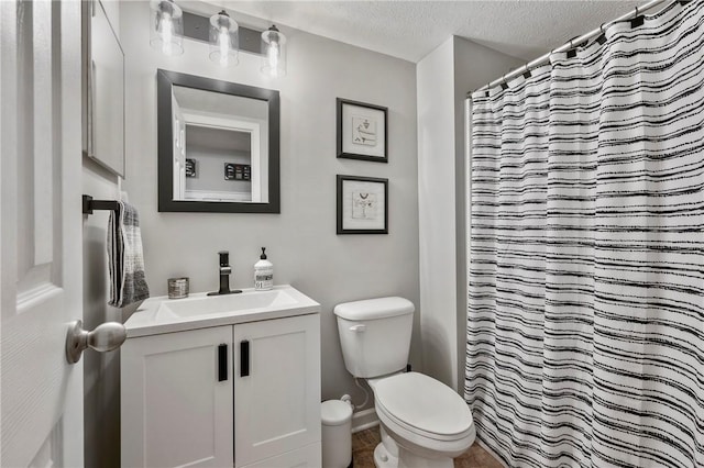 full bath with a shower with curtain, toilet, vanity, and a textured ceiling