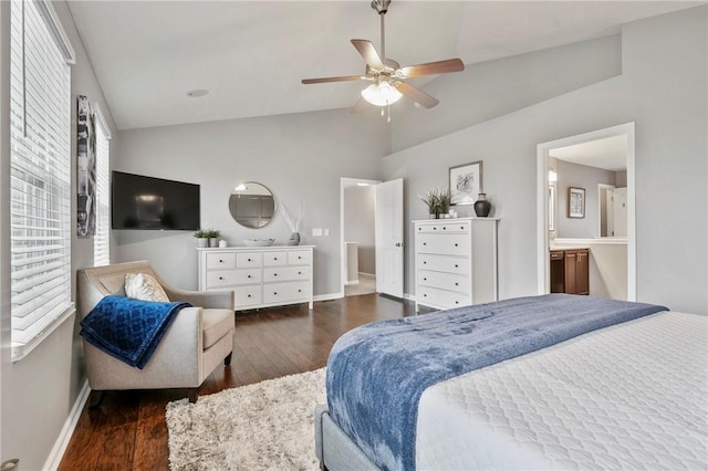 bedroom with vaulted ceiling, connected bathroom, baseboards, and wood finished floors