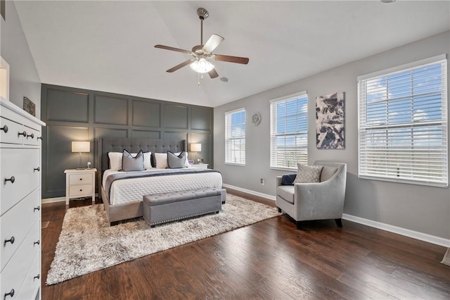 bedroom featuring dark wood-type flooring, baseboards, lofted ceiling, and ceiling fan