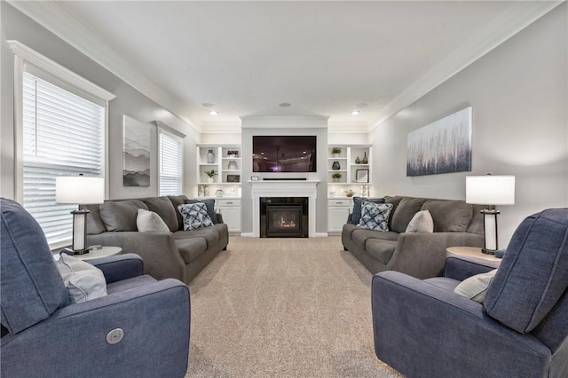 living room with a glass covered fireplace, light colored carpet, built in features, and ornamental molding