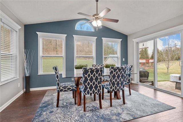 dining area with ceiling fan, baseboards, dark wood finished floors, and vaulted ceiling