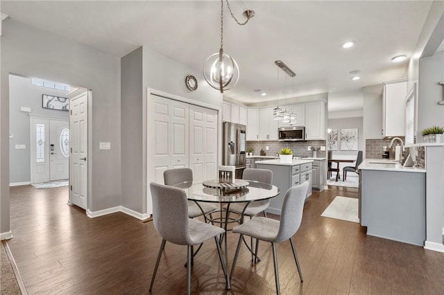 dining room with recessed lighting, baseboards, and dark wood-style flooring