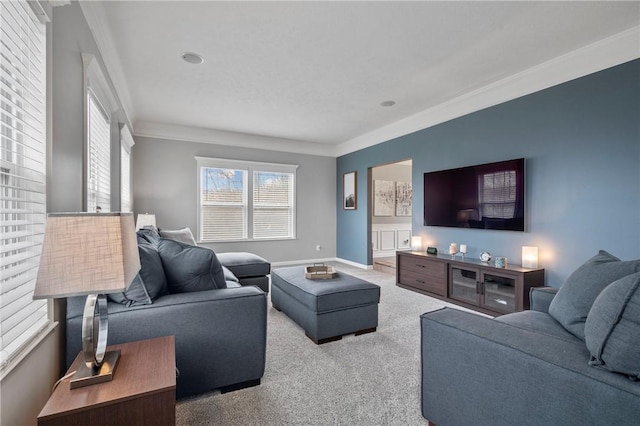 living area with ornamental molding, baseboards, and carpet floors