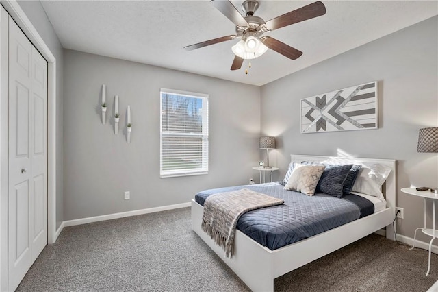 carpeted bedroom featuring a ceiling fan, baseboards, and a closet