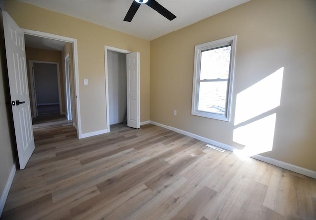 unfurnished bedroom with visible vents, baseboards, ceiling fan, and light wood finished floors